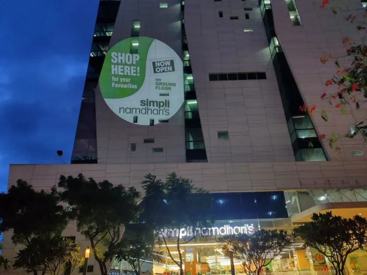 Brand advertising projected onto a building facade at night